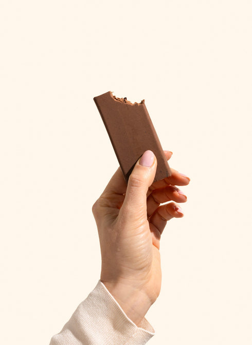 Betty Chocolate Fudge Protein Bar unwrapped, held in hand