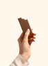 Betty Chocolate Fudge Protein Bar unwrapped, held in hand