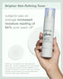 Natio Glow toner bottle held by a hand with text about skin moisture increase.