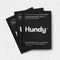 Image of 3 sachets of hundy showing they are black coloured with 2 capsules per sachet