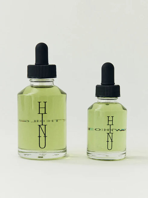 Two glass bottles with black droppers labeled 'HINU' on a white background