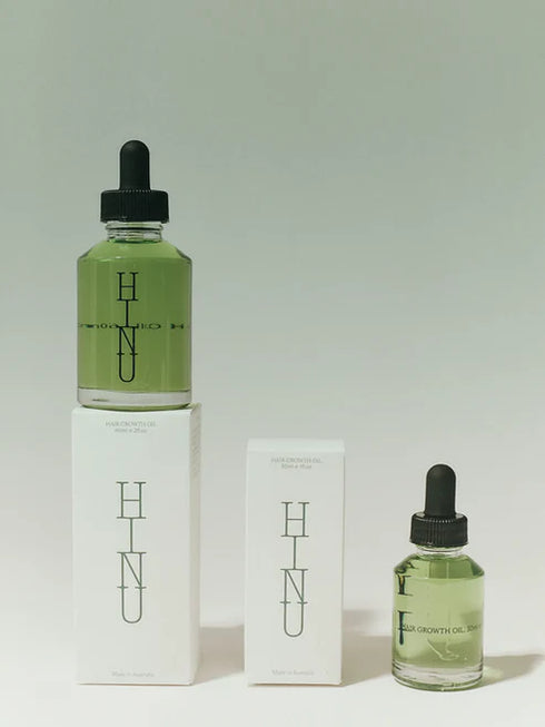 Two green bottles with black droppers and 'HINU' branding on a light gray background.