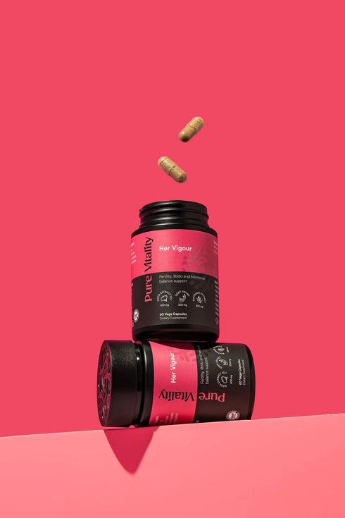 Image of Her Vigour 60caps bottle open with yellow capsules showing