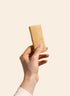 Betty Strawberry Cheesecake Protein Bar unwrapped, held in hand