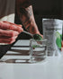Image of SuperGreens Top 7 Super Greens being stirred into glass