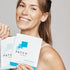 Image of a lady holding up a pack of daily detox patches