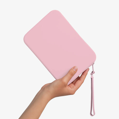 The Strapsicle Clutch in Blush, Large size, held in one hand