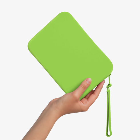 The Strapsicle Clutch in Neon Zest, Regular size, held in one hand