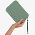 The Strapsicle Clutch in Sage, Large size, held in one hand