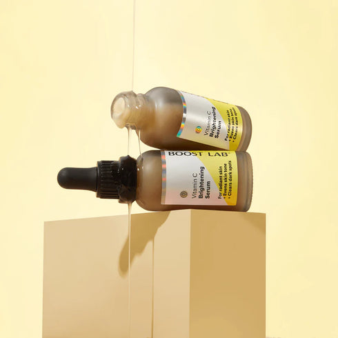 Image of Boost Lab Vitamin C brightening serum pouring out of bottle