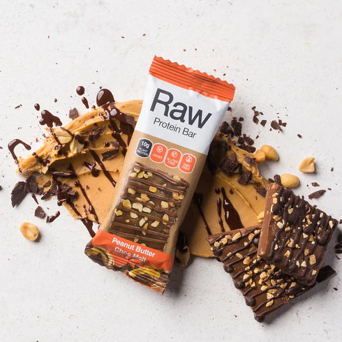Image of Raw Protein Bar - Peanut Butter and chocolate in the background