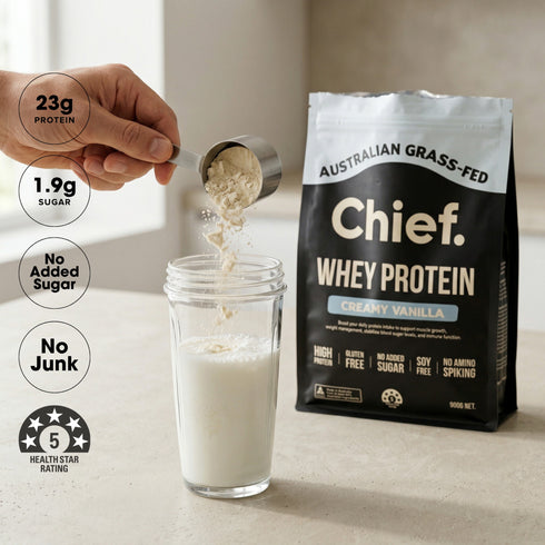 Chief Creamy Vanilla whey protein scooped into milk, 23g protein per serve