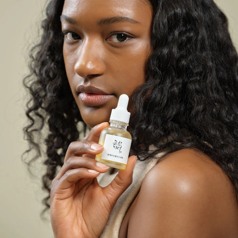 Image of woman holding Glow Serum: Propolis + Niacinamide