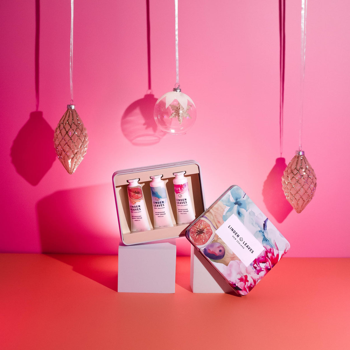 Linden Leaves hand cream selection tin, open, beside baubles