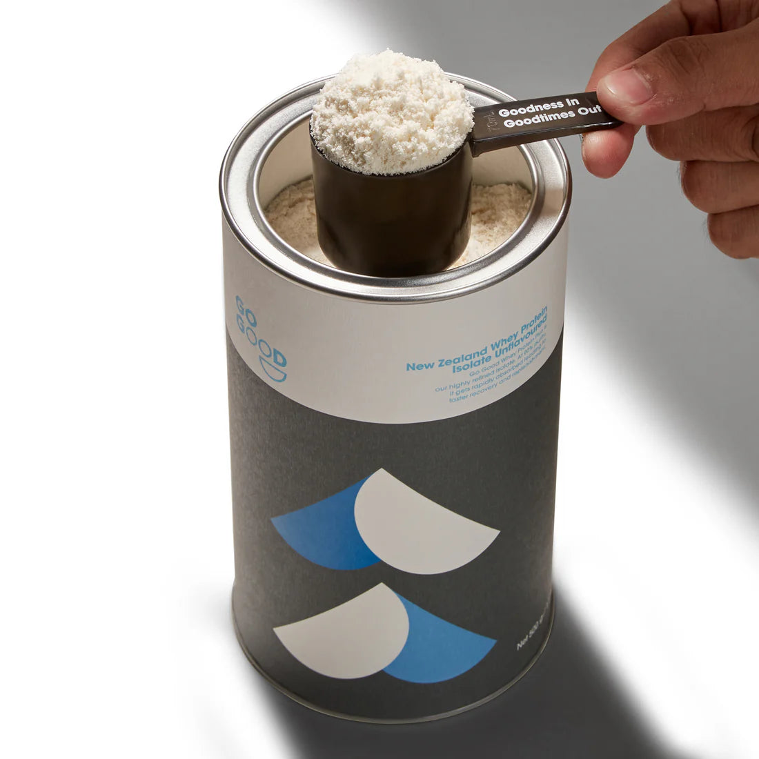 Go Good Unflavoured Whey Protein Isolate tube open with a scoop of the unflavoured powder held above it