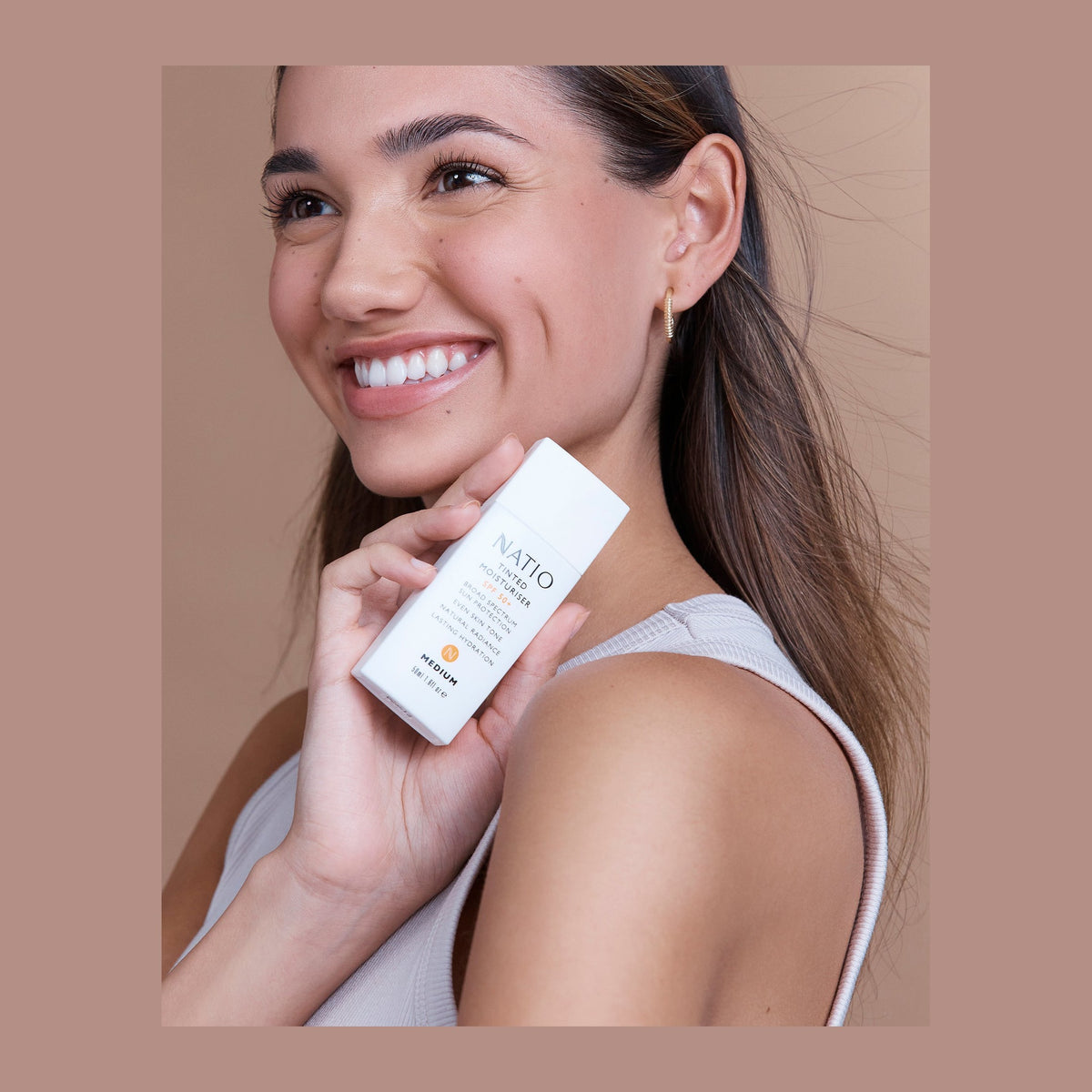 Natio Tinted Moisturiser SPF50 Medium shown in use