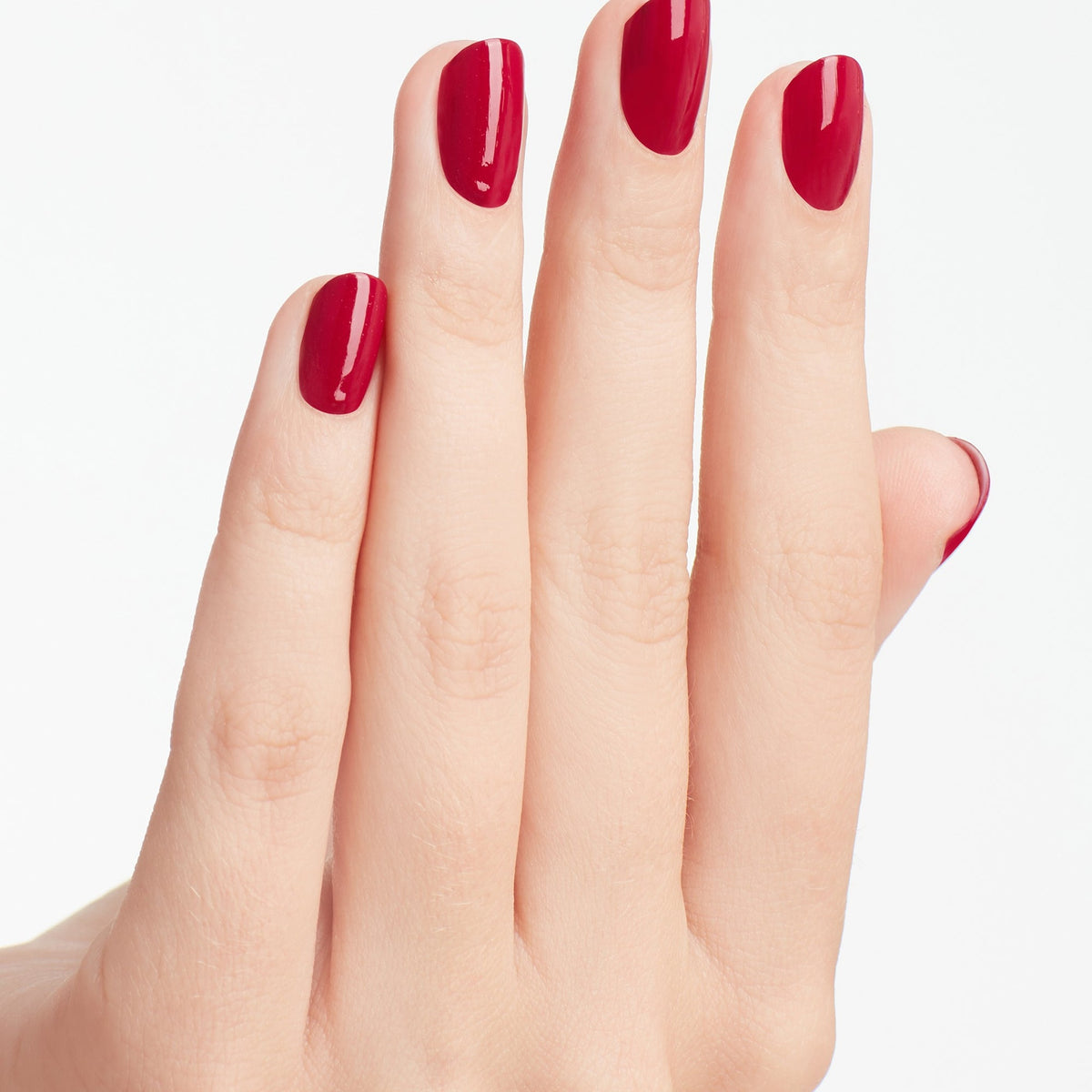 A manicure painted in OPI Miami Beet