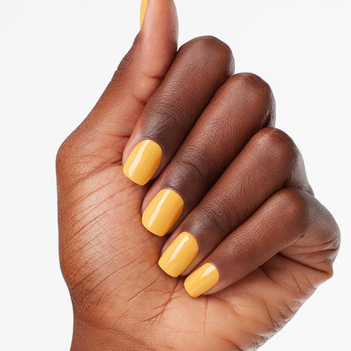 A manicure painted in OPI Marigolden Hour