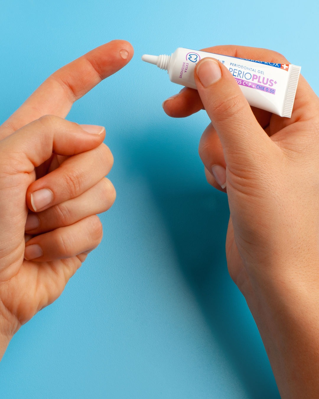 Curaprox Perio plus focus 10ml tube held in one hand