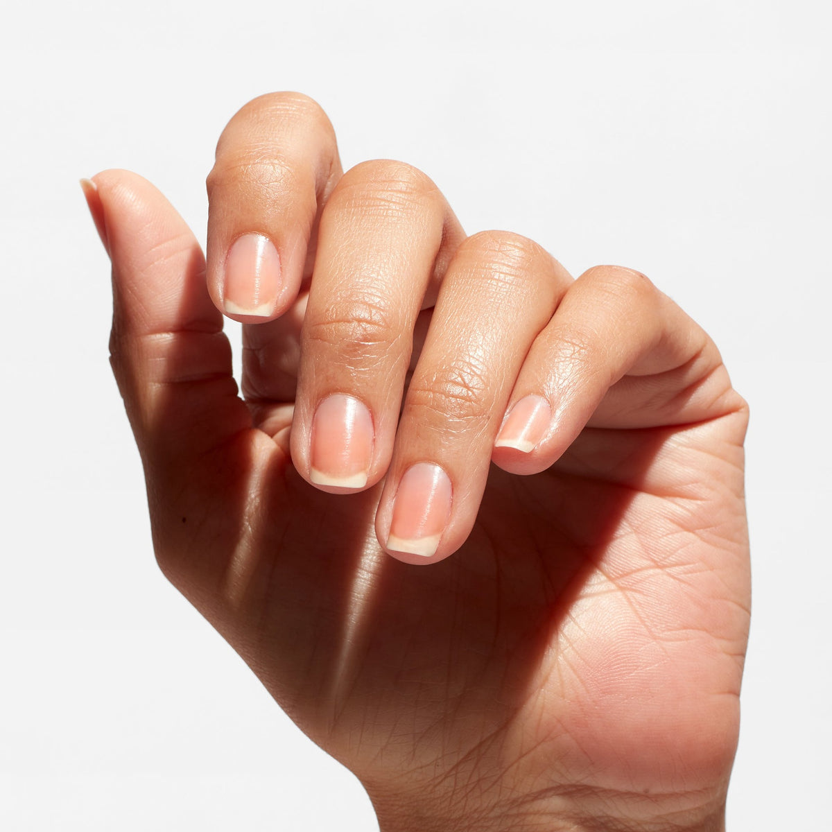 A manicure painted in OPI Natural Nail Base Coat