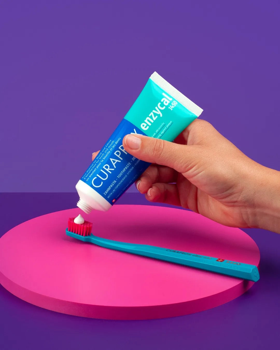 Curaprox Enzycal 1450 being squeezed onto an interdental brush