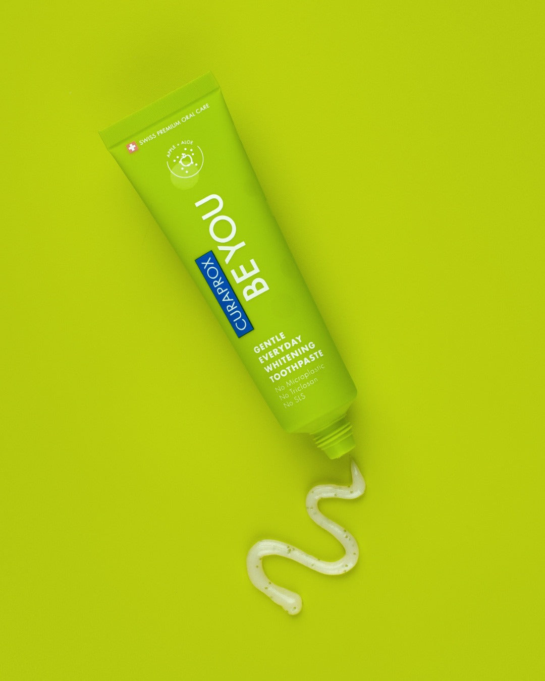 Curaprox Be you Apple and Aloe green tube on a green background