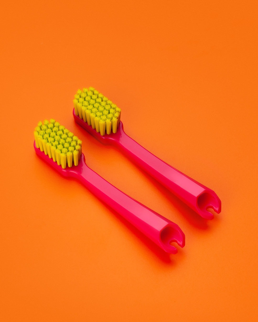 Curaprox travel set brush heads on an orange background