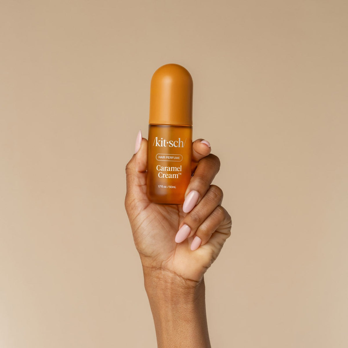Kitsch Caramel Cream mist held in one hand