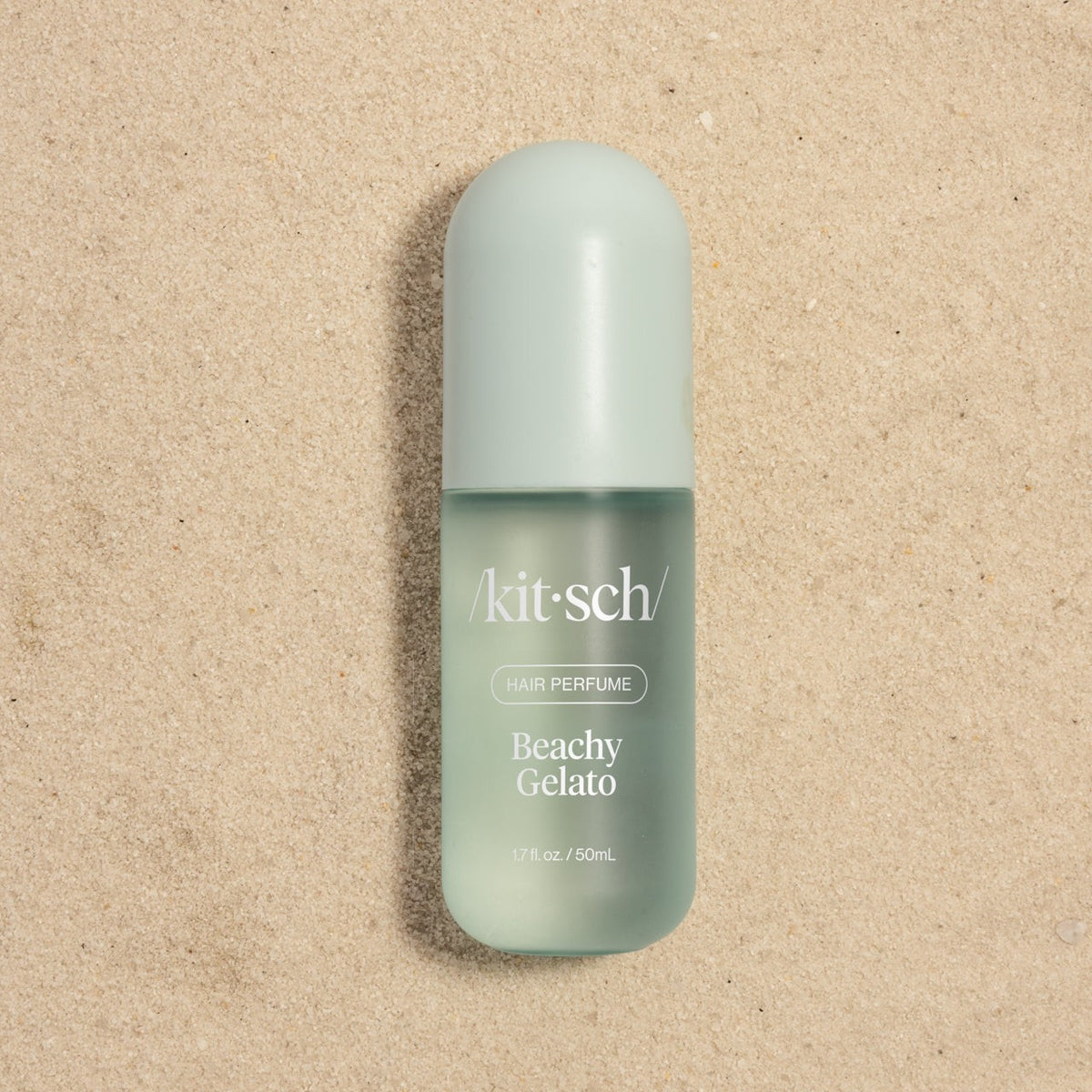 Kitsch Beachy Gelato bottle lying on sand