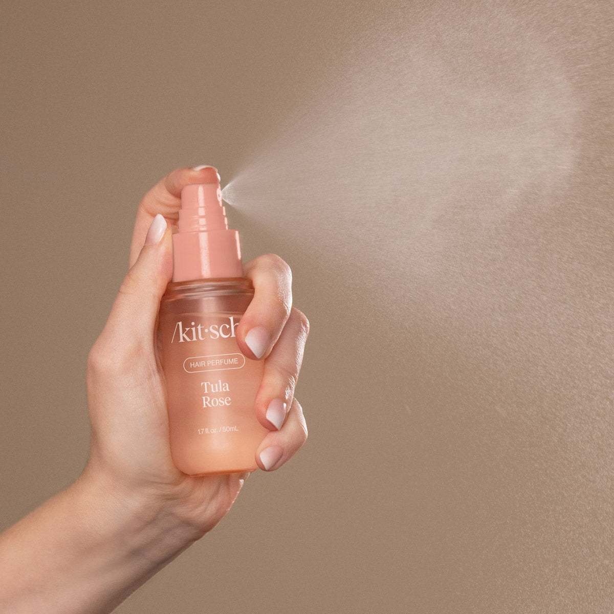 Kitsch Tula Rose mist being sprayed, showing the fine mist