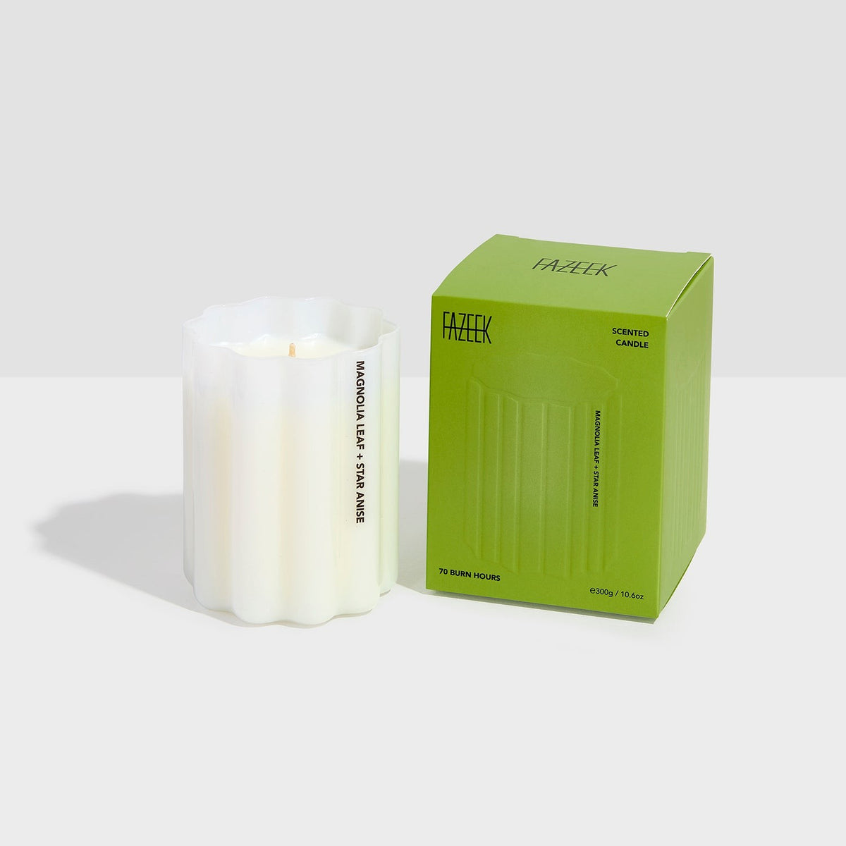 Fazeek Wave Candle in Magnolia Leaf and Star Anise beside its green box