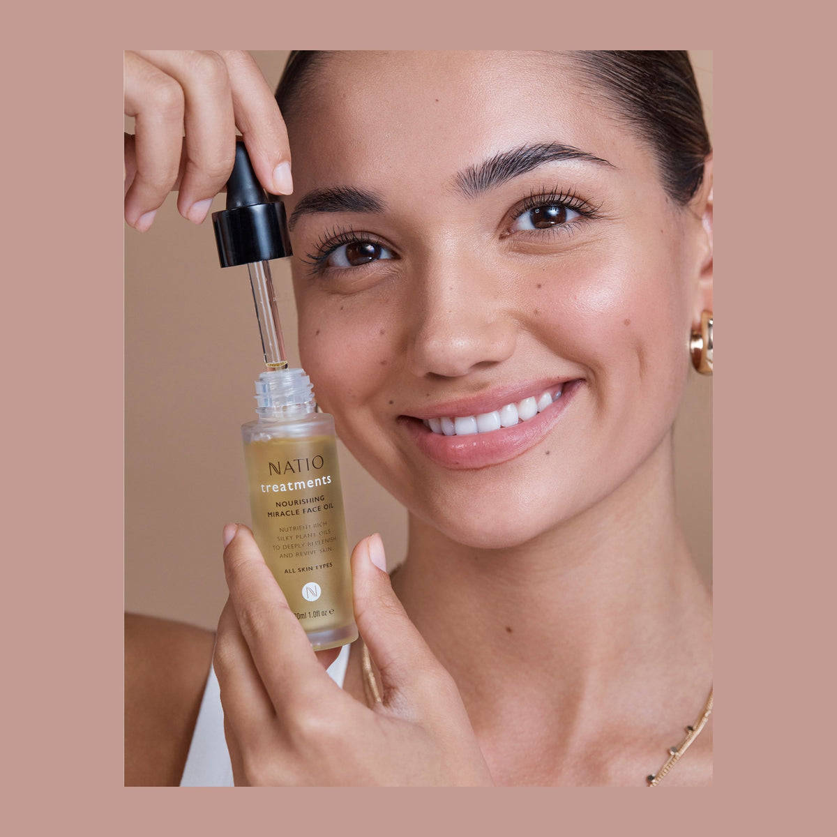 Natio Treatment Nourishing Miracle Face Oil 30ml shown in use