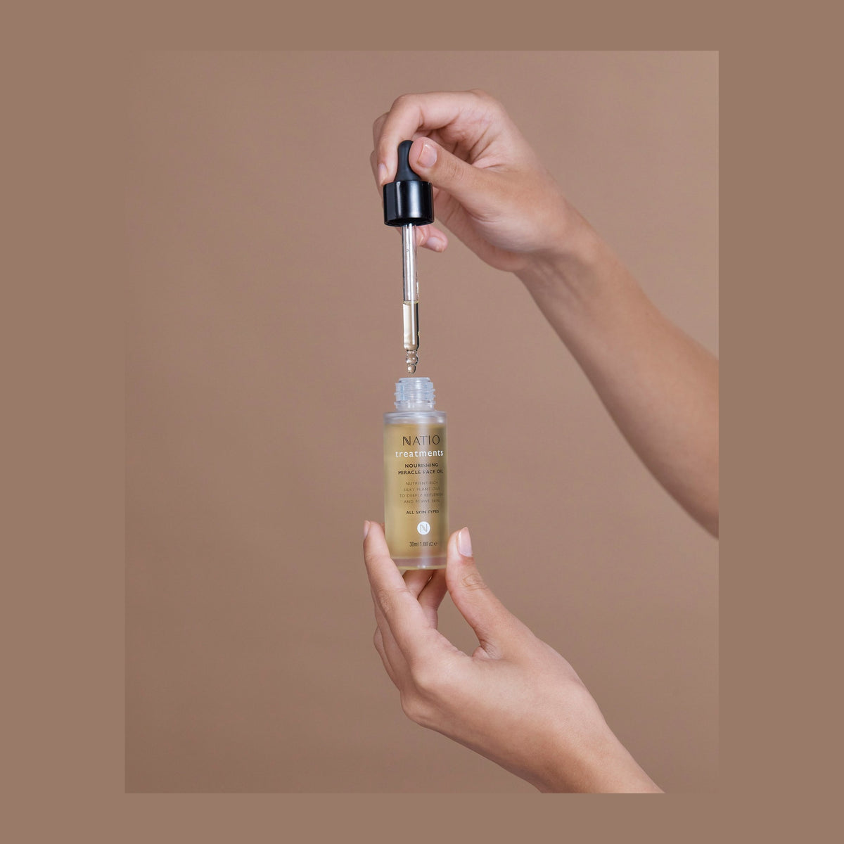 Natio Treatment Nourishing Miracle Face Oil 30ml shown in use