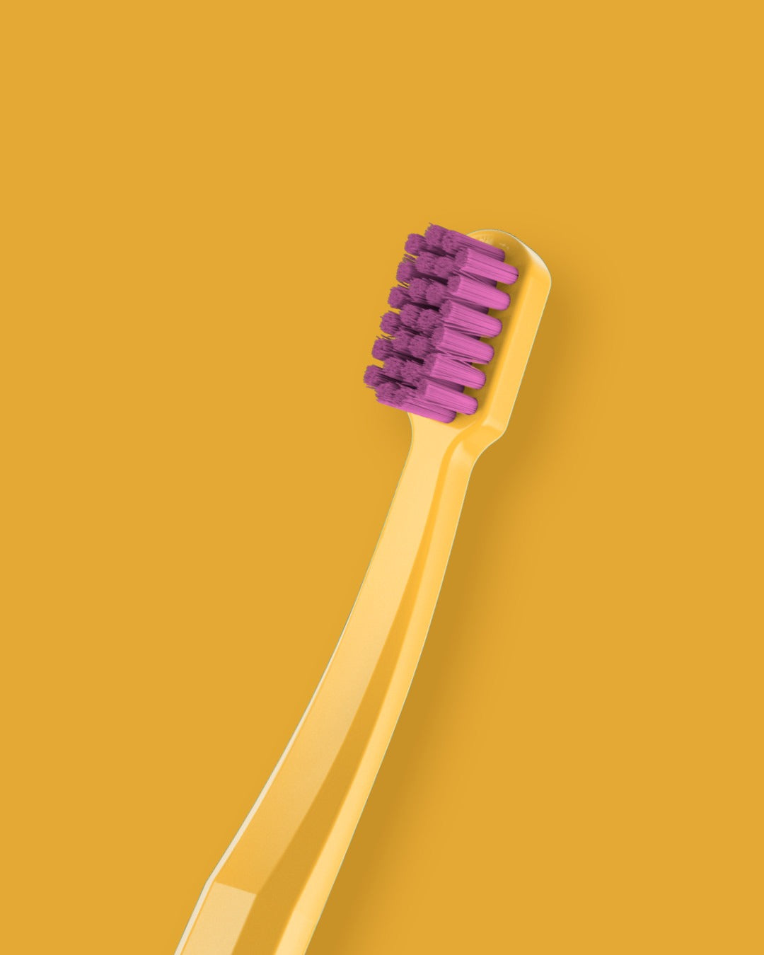 Curaprox CS smart toothbrush on a yellow background