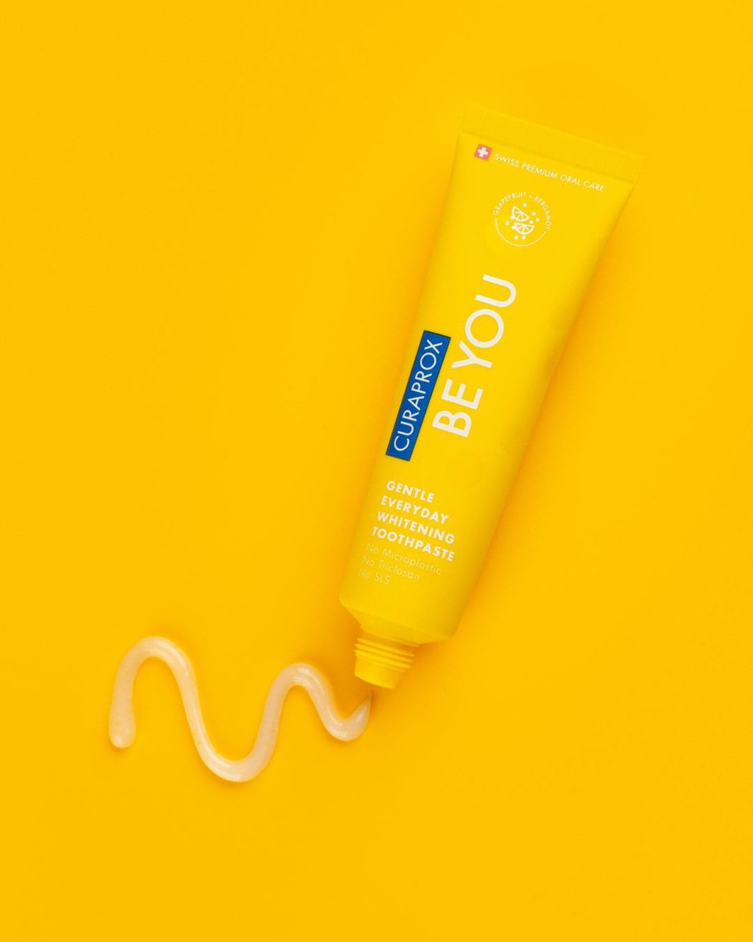 Curaprox Be you Grapefruit and Bergamot yellow tube with a paste swirl