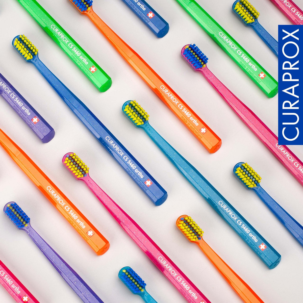 Curaprox CS 5460 ortho toothbrushes laid out in the assorted colour range