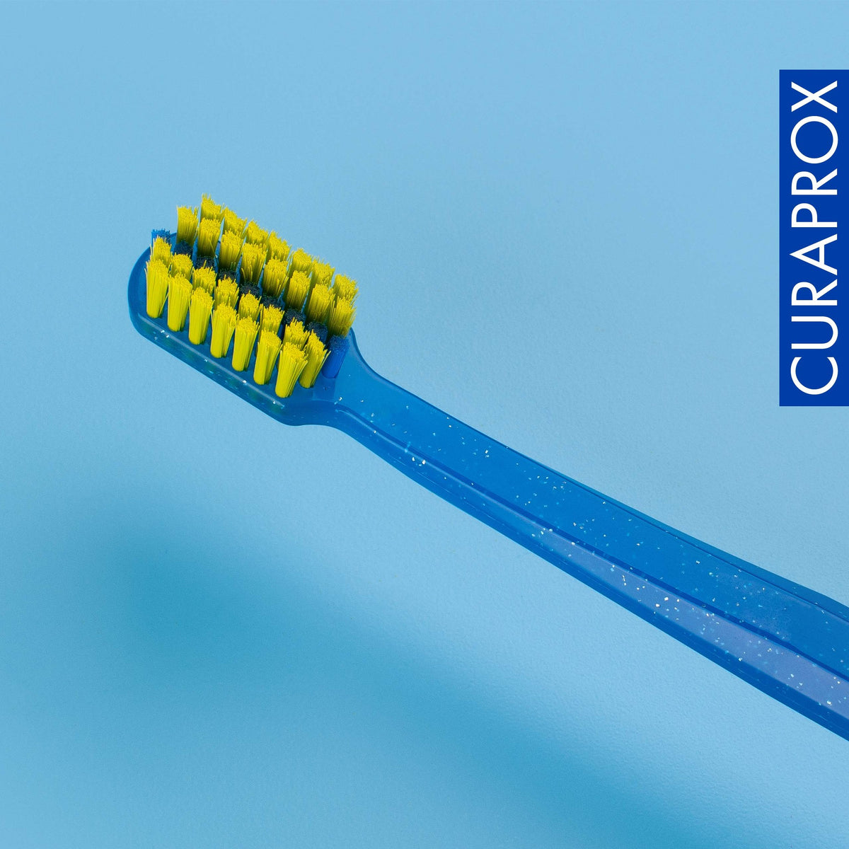 Curaprox CS 5460 ortho toothbrush on a blue background