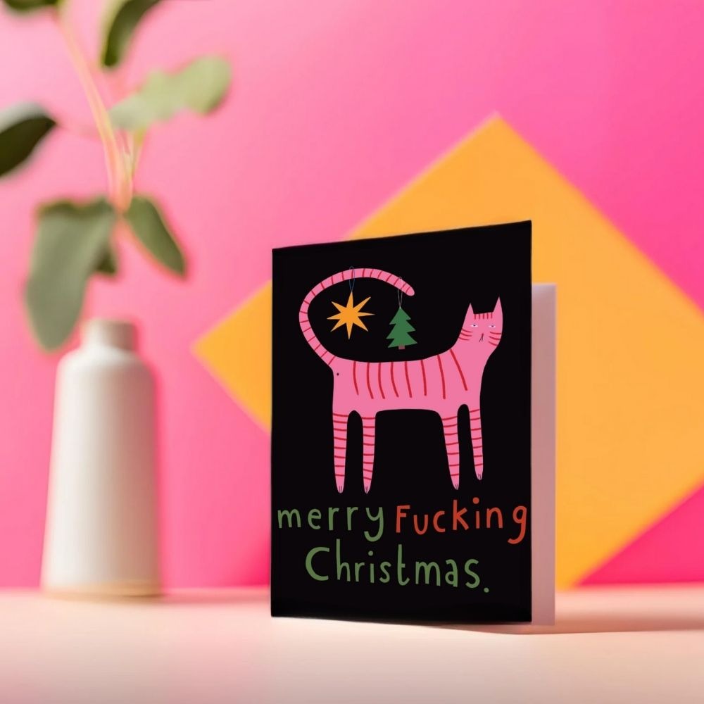 The Studio Soph Christmas card standing against a pink and yellow backdrop