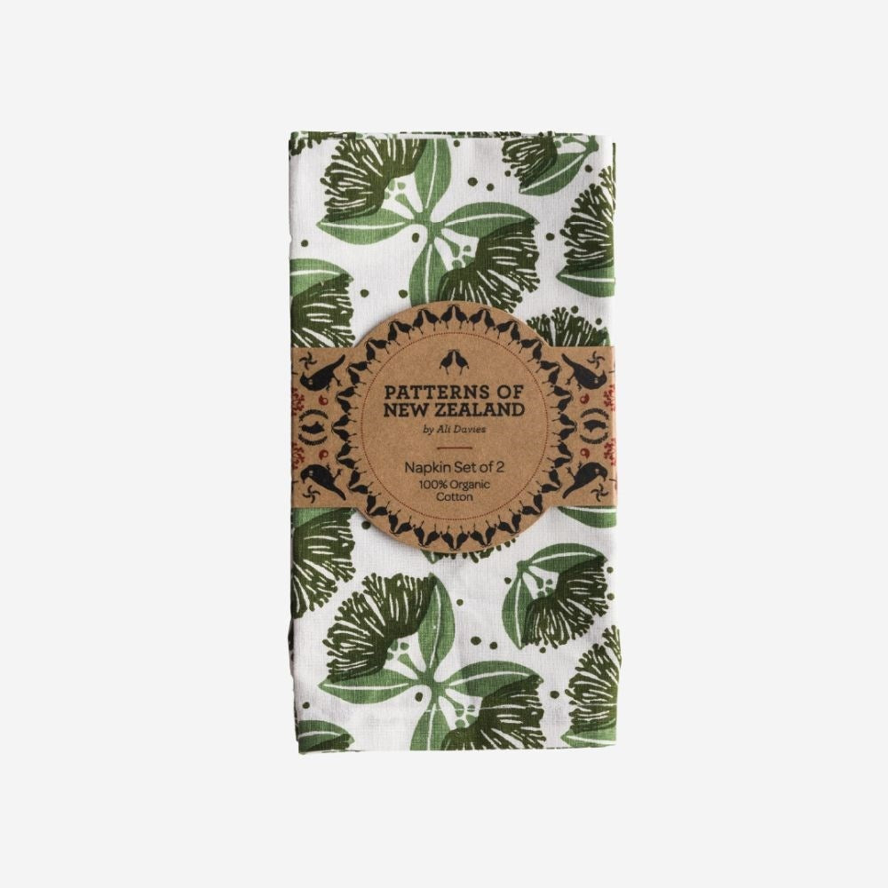 Ali Davies pohutukawa napkins in shades of green, folded in their paper band