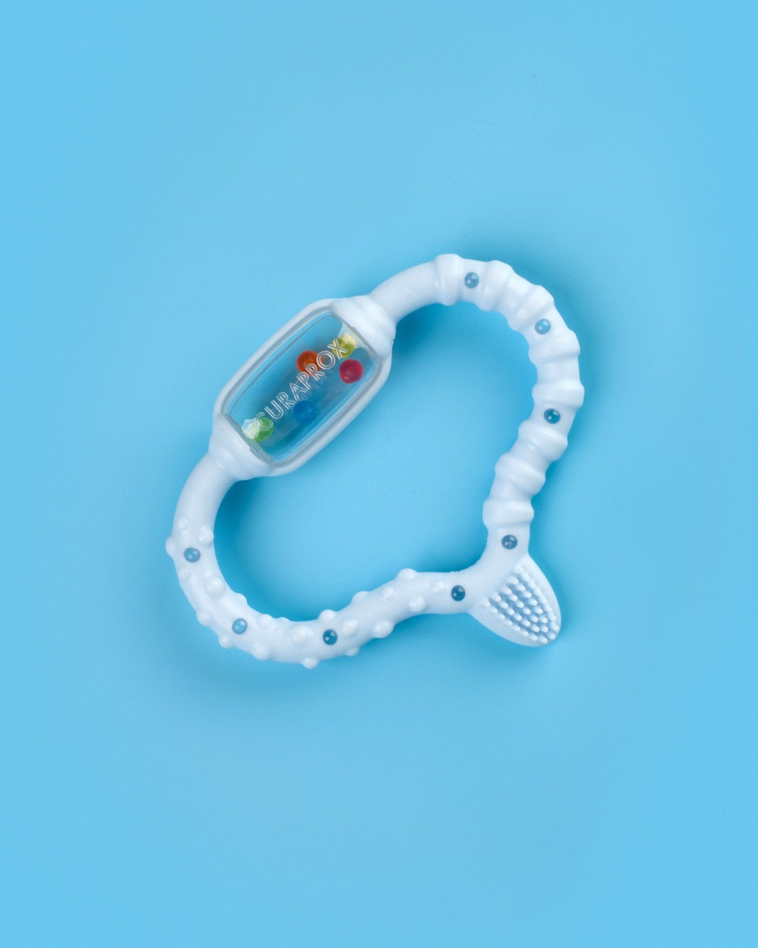 Curaprox baby teething ring on a blue background