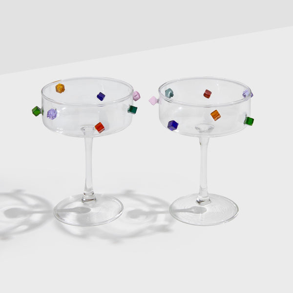 A pair of Fazeek Jewel Coupes on a grey background, showing the coloured glass cubes around each bowl