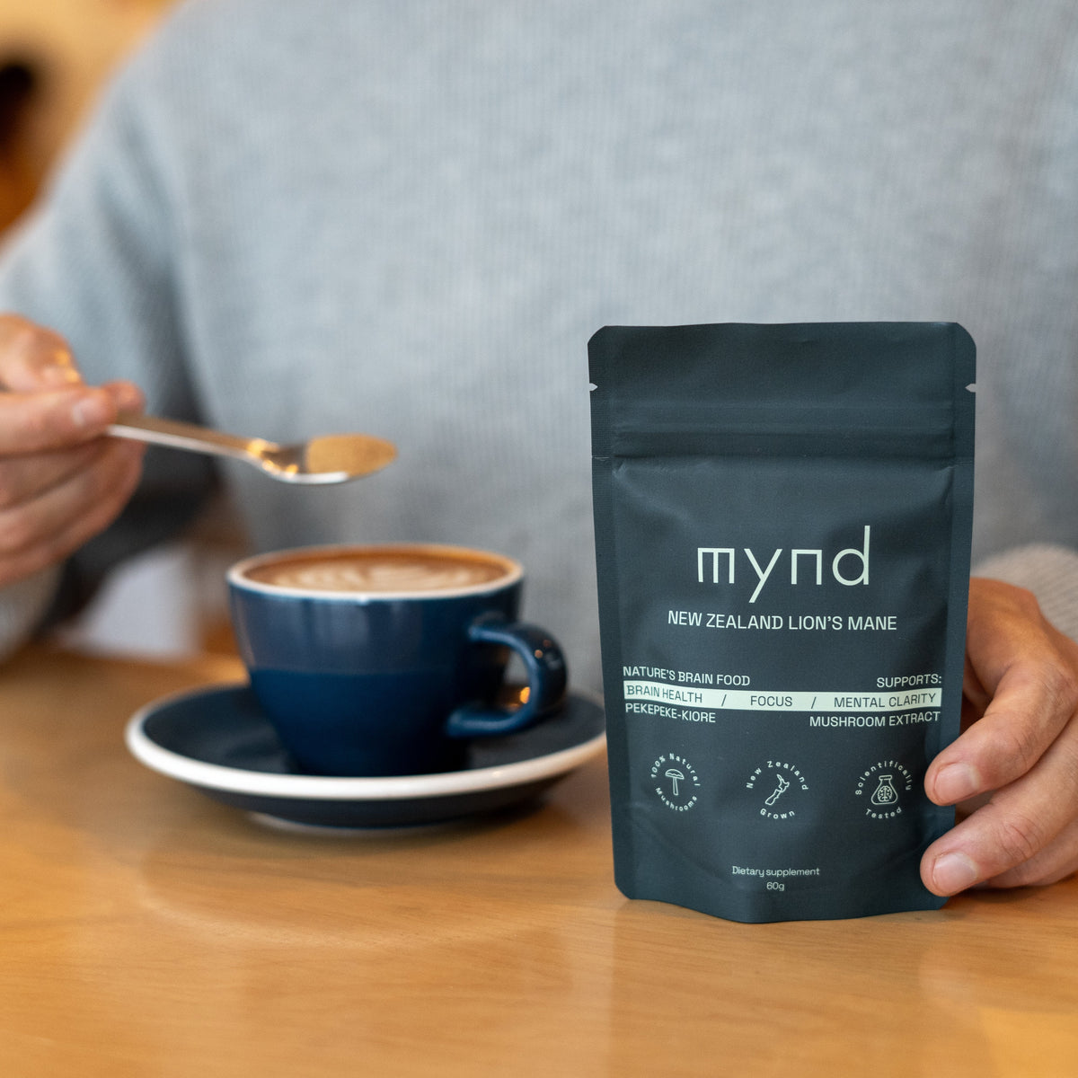 Mynd Lion's Mane powder being stirred into a coffee