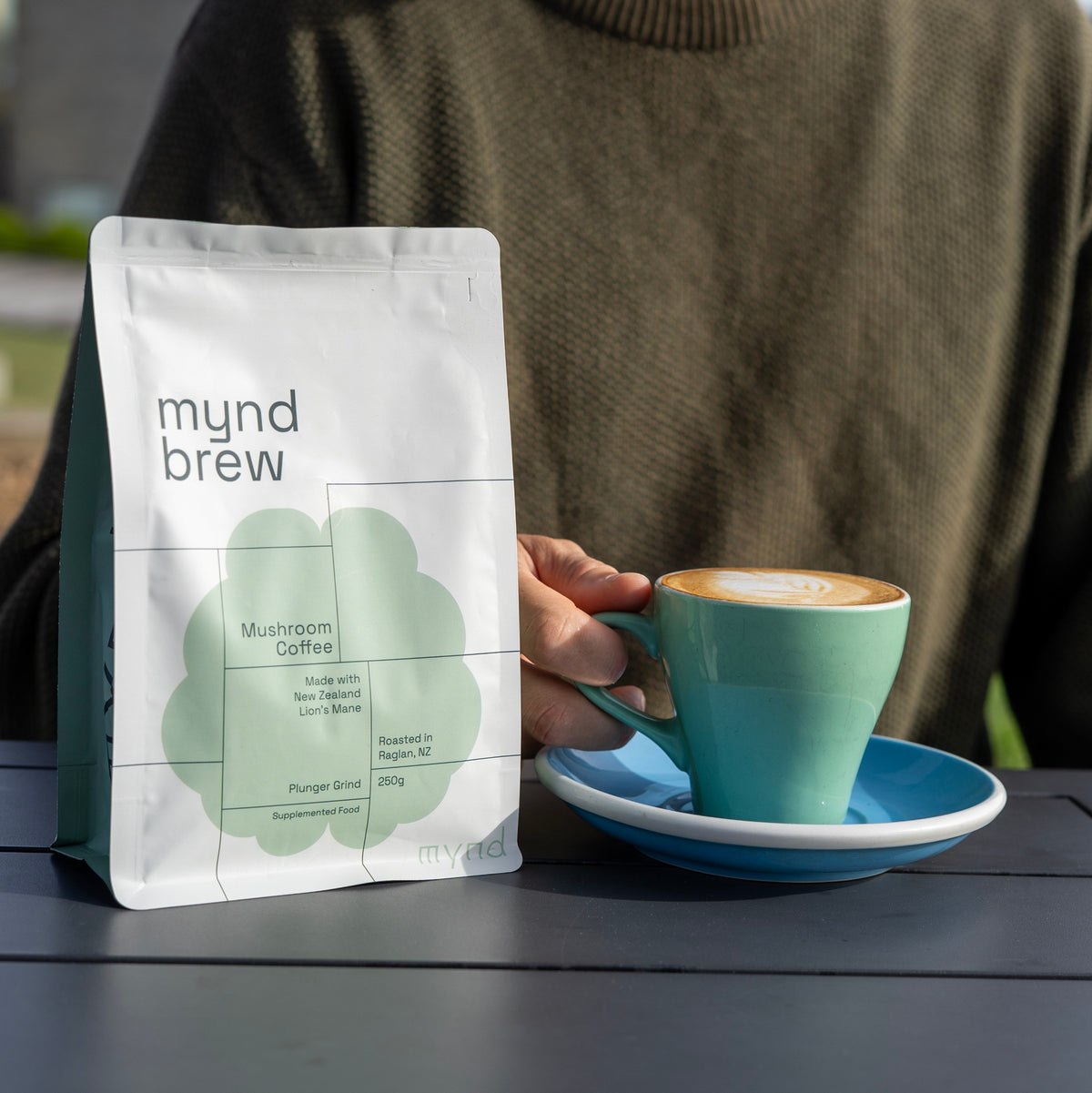 Mynd Brew coffee bag on a table with a flat white