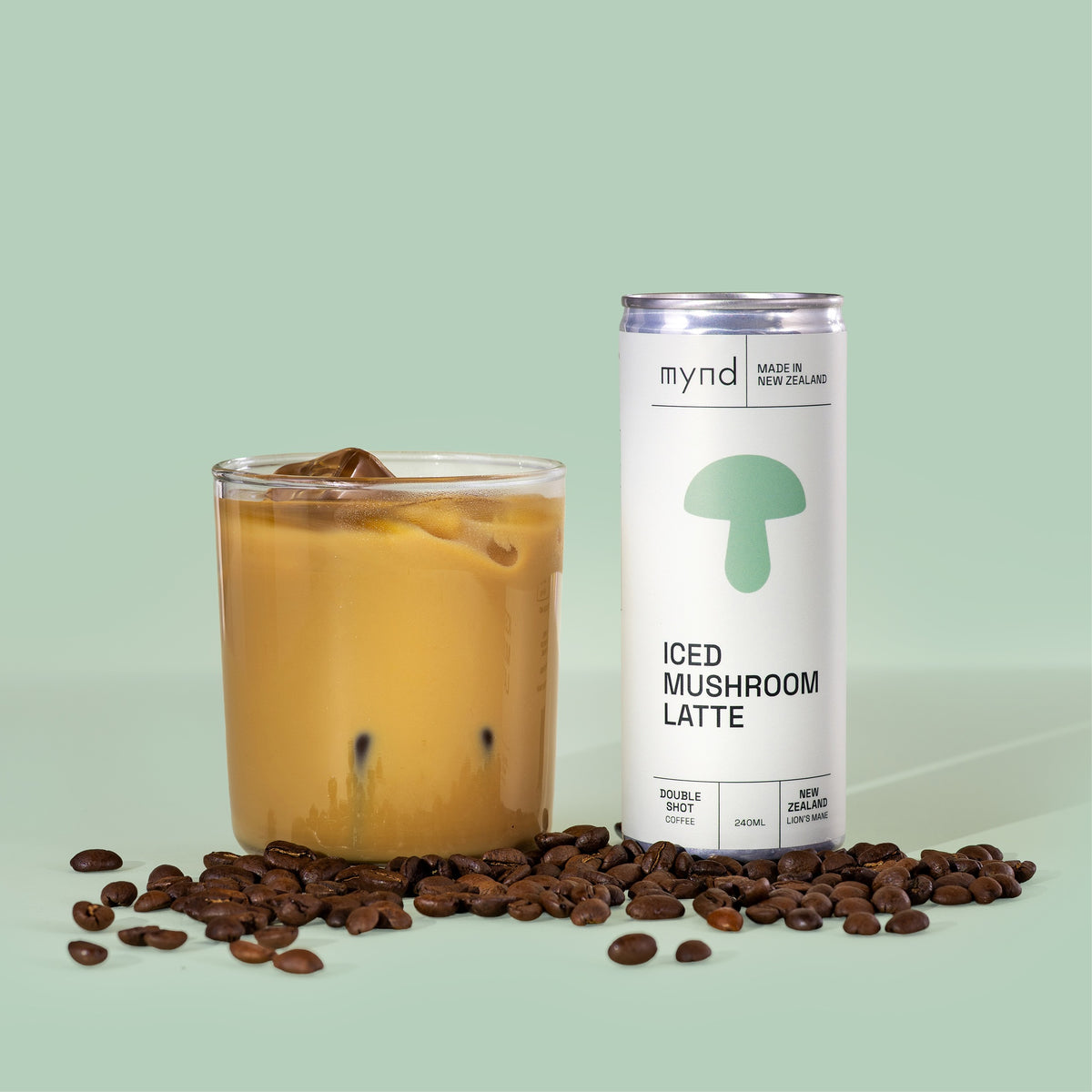 Mynd Iced Mushroom Latte poured into a glass with coffee beans