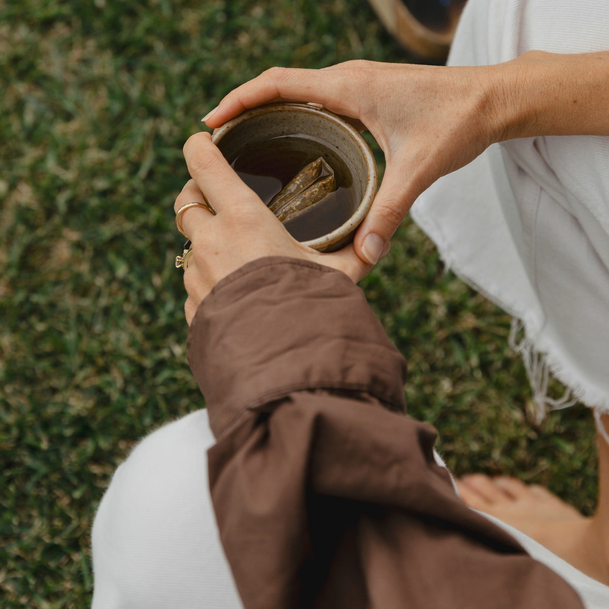 A cup of Matcha Green Tea held outdoors