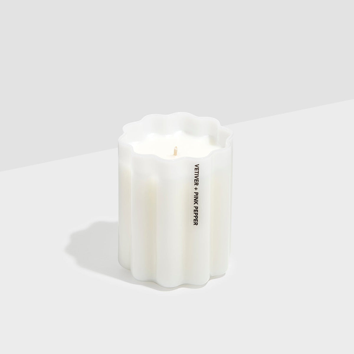 Fazeek Wave Candle in Vetiver and Pink Pepper seen from the front, wick untrimmed