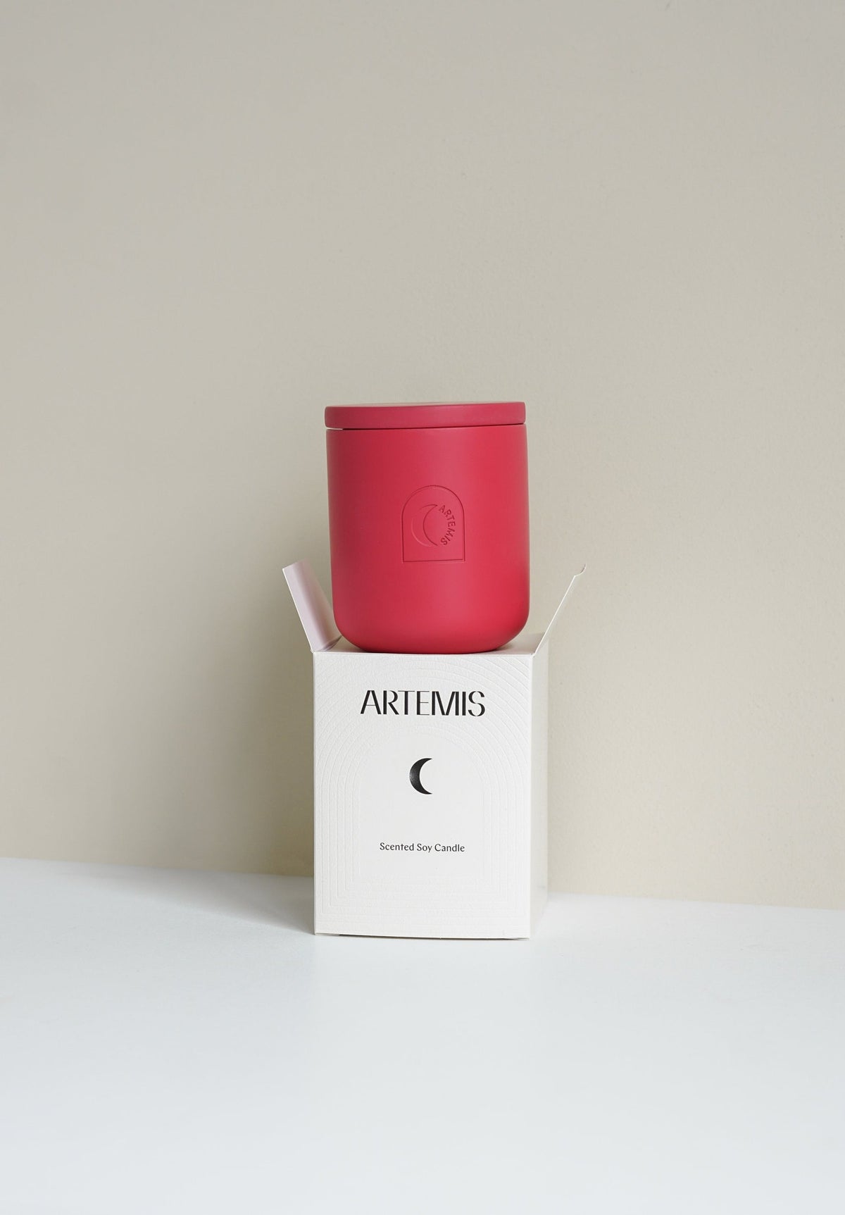 Artemis Festive Delight soy candle in a red vessel beside its box