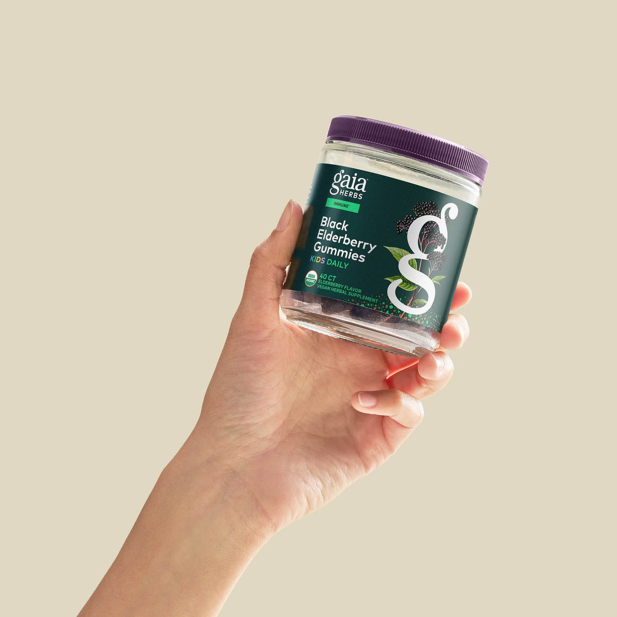 Gaia Herbs GaiaKids Black Elderberry Kids Daily Gummies held in hand