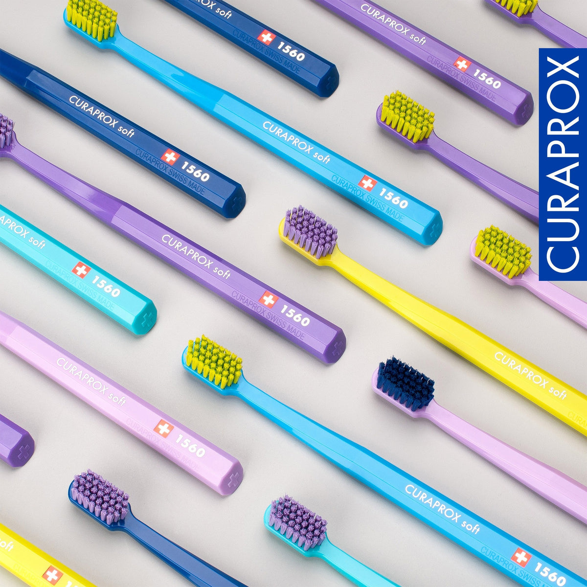 Curaprox CS 1560 toothbrushes laid out in the assorted colour range