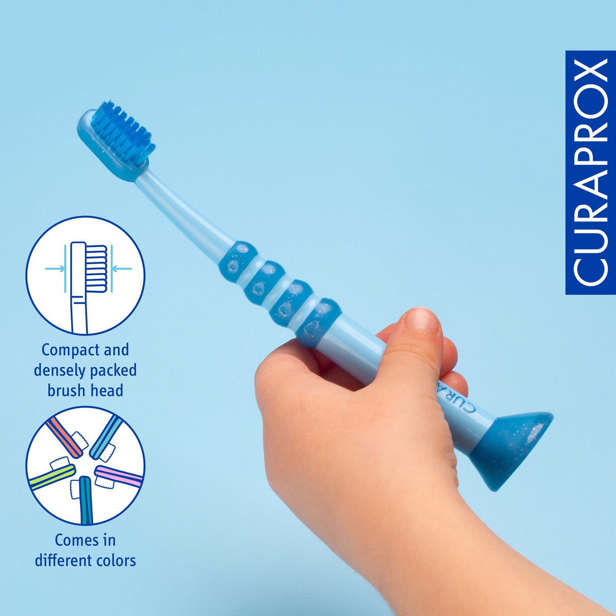 A small hand holding the Curaprox baby toothbrush by its wide grip